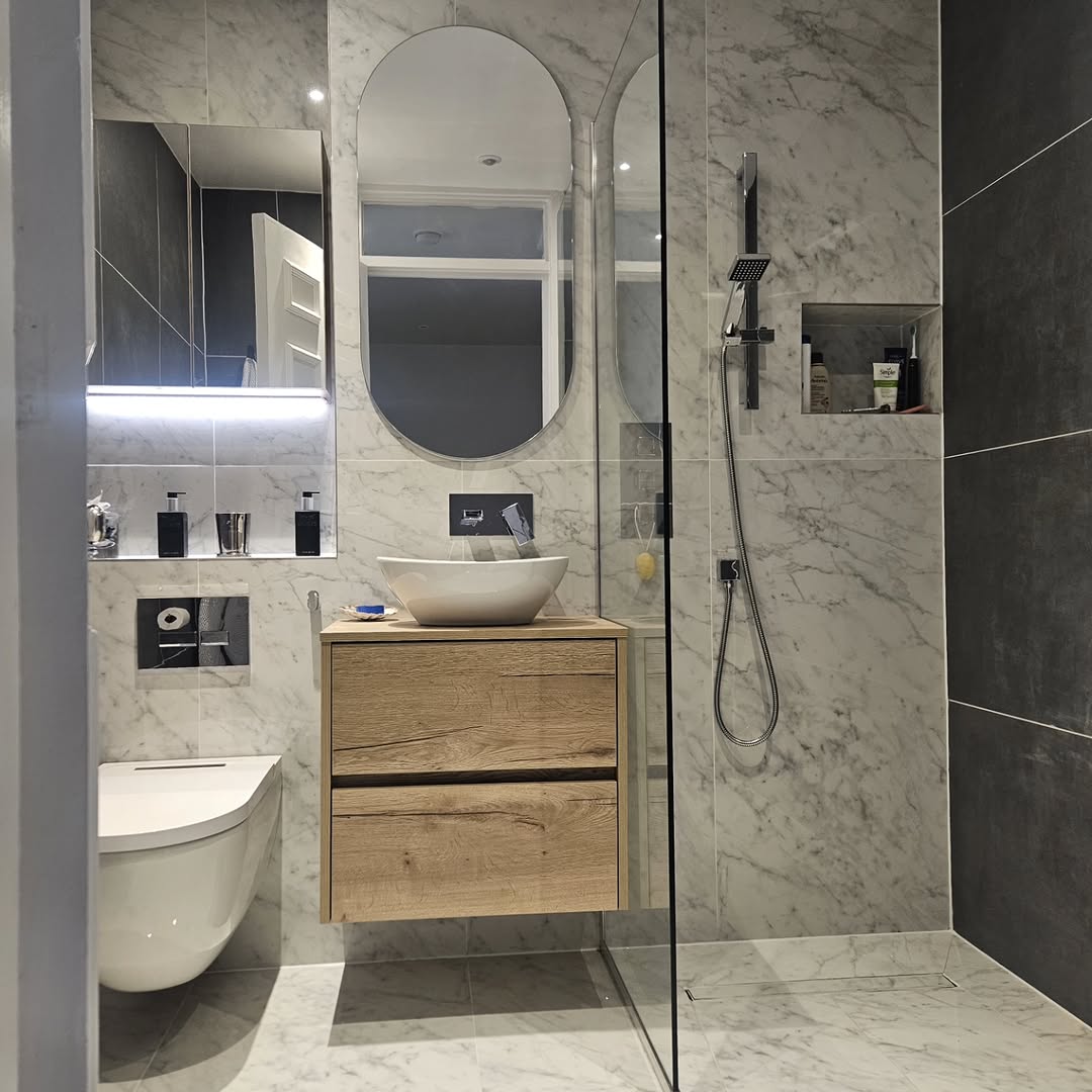 Marble bathroom with walk-in shower and oak vanity