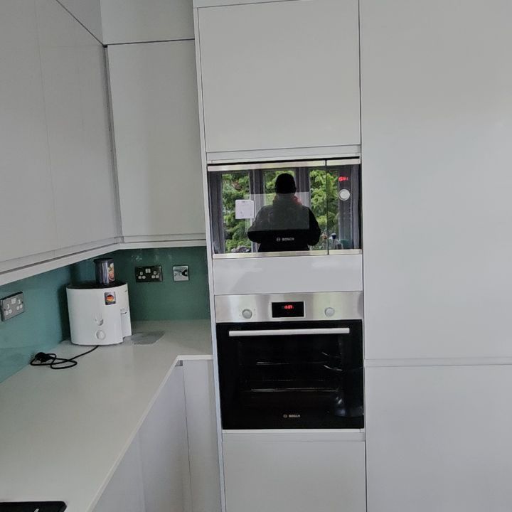 Fitted white kitchen with built-in ovens